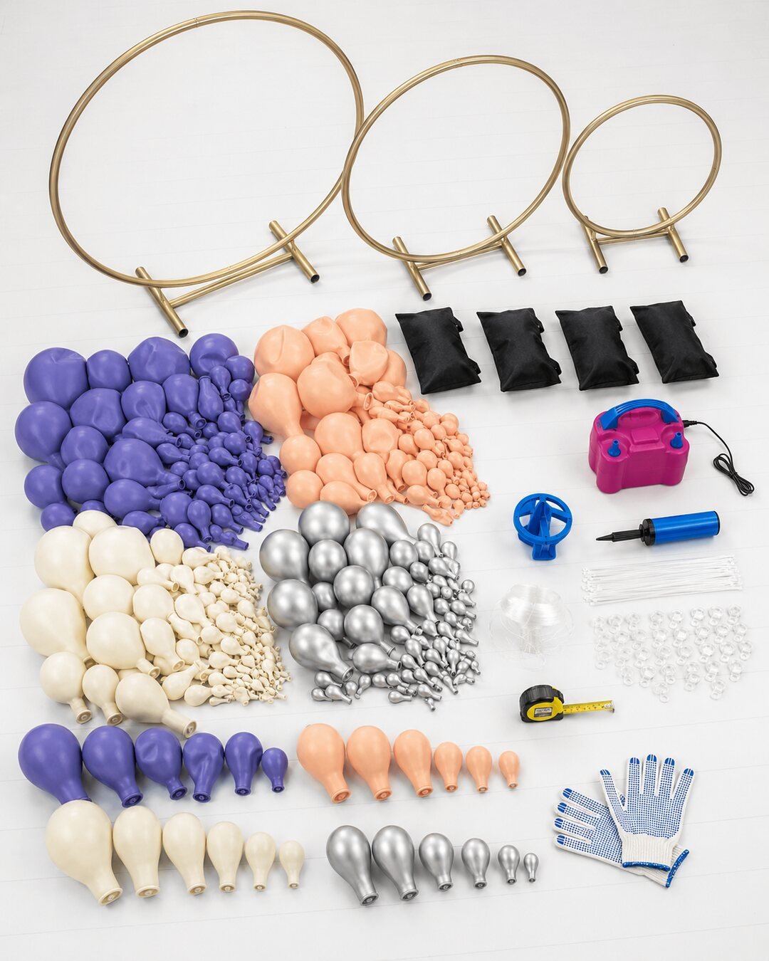 Gold ring stands balloons inflator sizer sandbags ties and tools arranged for a celestial orbit balloon wall