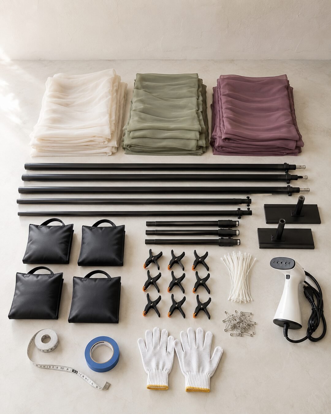 Ivory sage and muted plum chiffon panels with a backdrop frame sandbags clamps steamer and installation tools