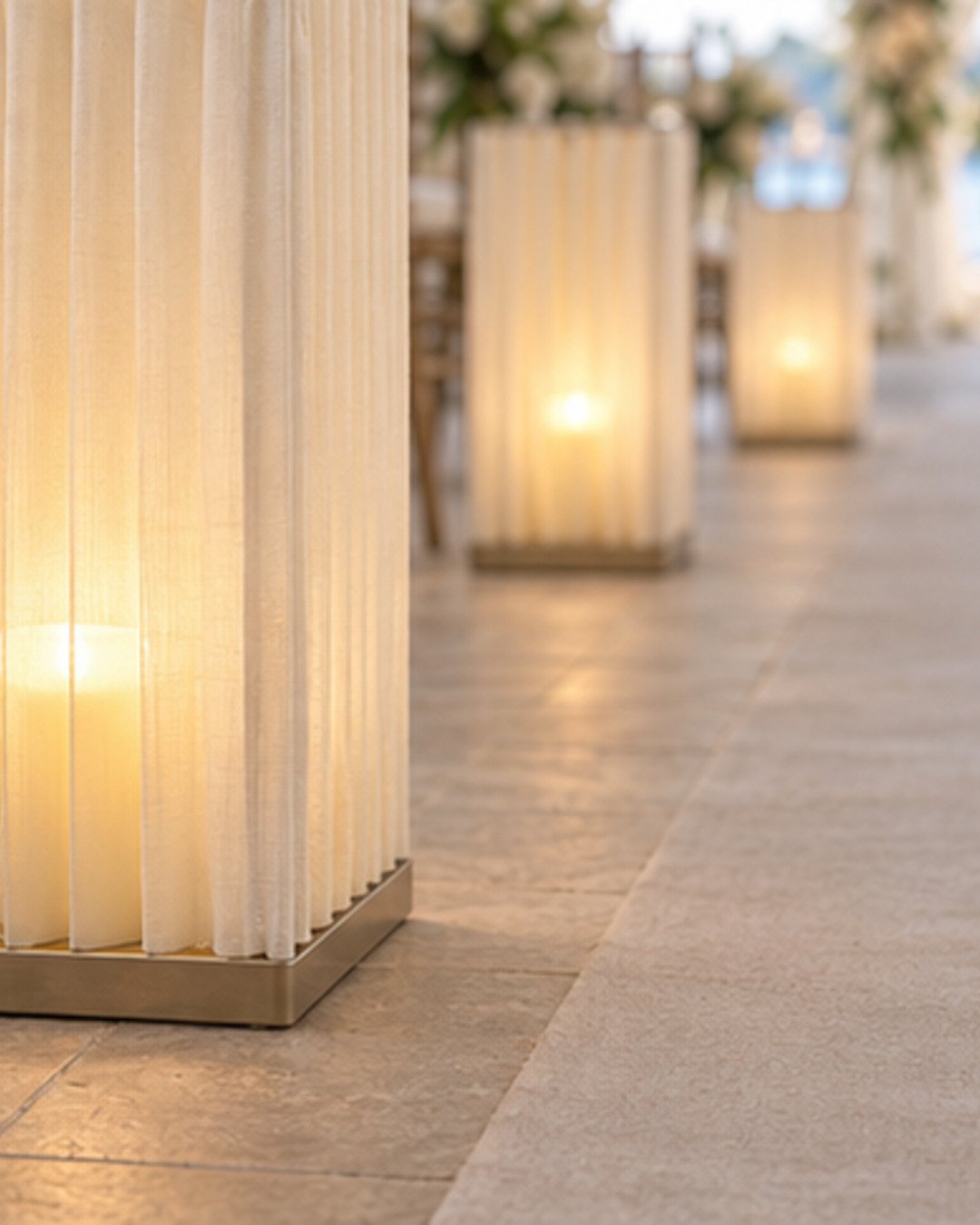 Close view of elegant pleated-linen wedding aisle lanterns with refined warm lighting